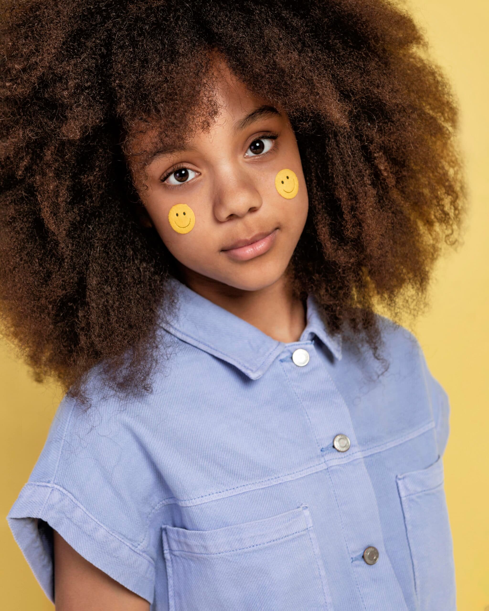 portrait-young-adorable-girl-posing-with-emoji-stickers-her-face portrait-young-adorable-girl-posing-with-emoji-stickers-her-face