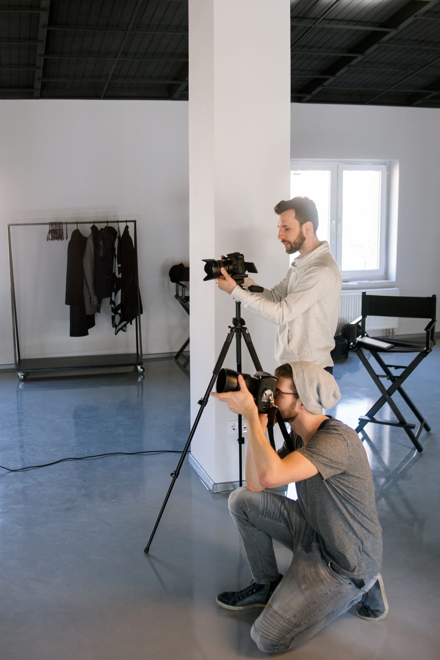 Two photographers taking shots in studio