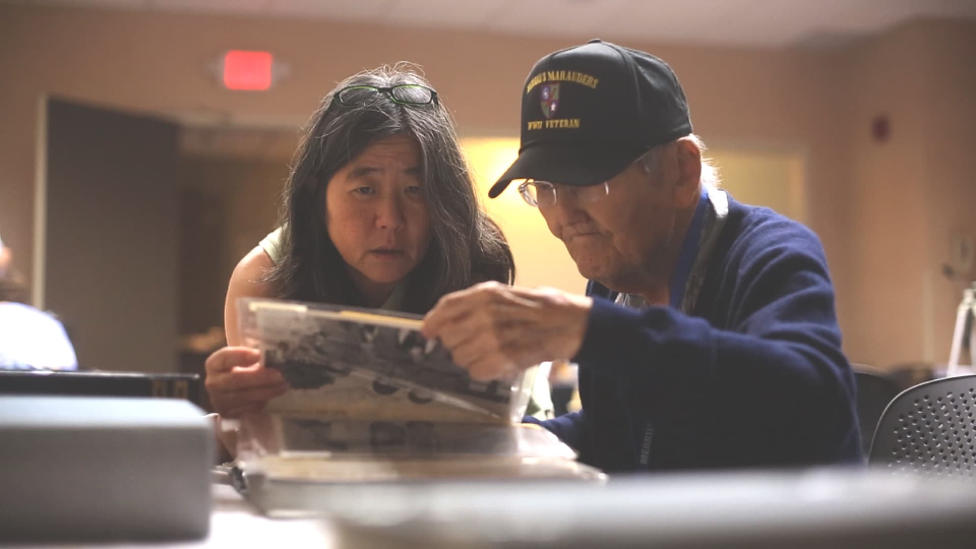 Karen-and-Roy-Matsumoto-look-at-old-pictures-at-a-Merrills-Marauders-Reunion